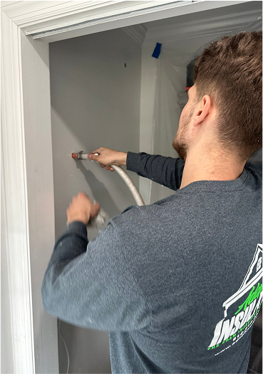 Man injecting foam into a wall