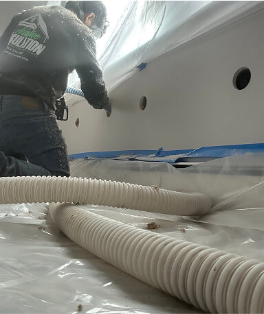Low view of a person injecting foam into wall
